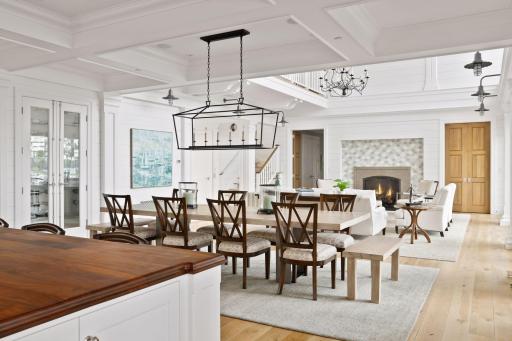 The spacious dining room with a beautiful light fixture and wine gallery.