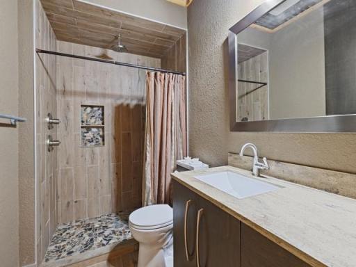 Common bathroom with custom walk-in tile shower