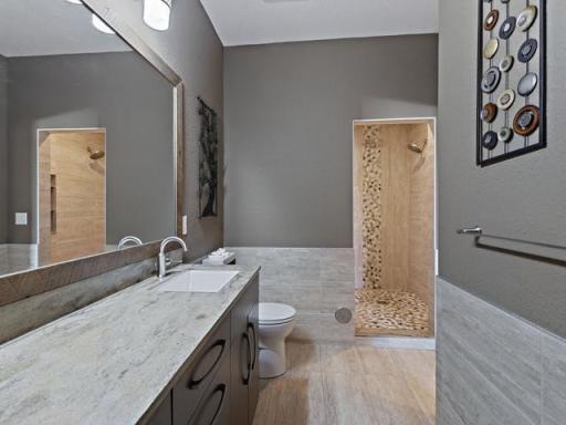 Private primary bathroom with custom tile walk-in shower