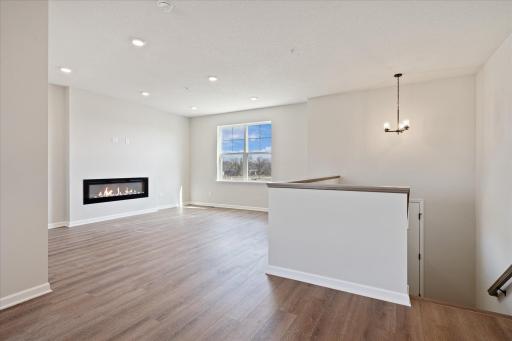 A very open floorplan. The actual unit has electric fireplace with a box mantle.