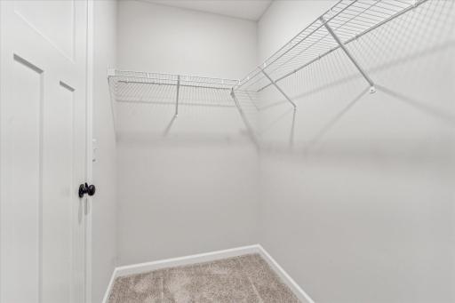 One of two walk-in closet's in owners bedroom.