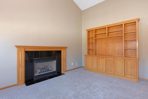 A closer look at the fireplace and built in cabinet.