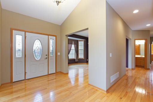 Vaulted foyer with nice and bright hardwood floors.