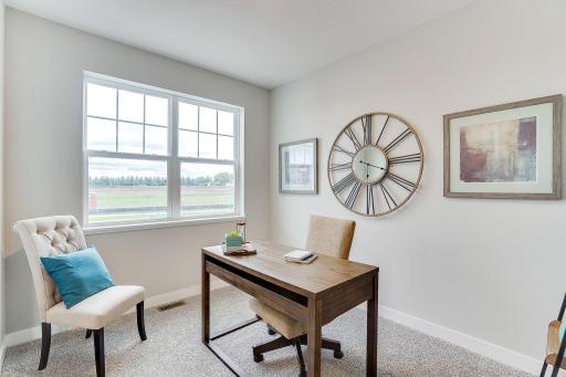 Located in the front of the home - this main level flex room provides endless opportunities; including a home office, formal dining area, an extra playroom or another sitting room. Photo of model, colors & options will vary.