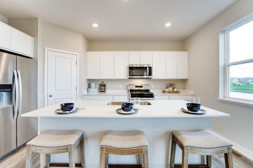Conveniently located in the corner of the kitchen is a walk-in pantry, providing plenty of storage space! Photo of model, color and options will vary.