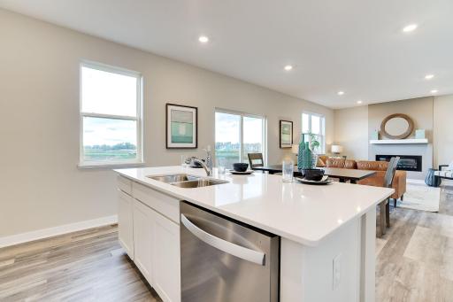 The open layout provides an optimal area to cook and entertain. Envision gathering together with friends and family in the heart of this home over the holidays! Photo of model, colors & options will vary.
