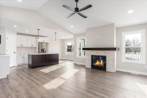 Bright and open floor plan with gas fireplace and vaulted ceilings.