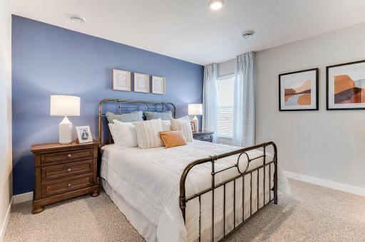 Beautiful primary bedroom upstairs with private ensuite bathroom and walk-in closet. Photo of model home, color & options will vary.