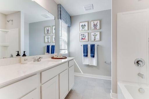 Those bedrooms are serviced by this full bath! Photo of model home, color & options will vary.