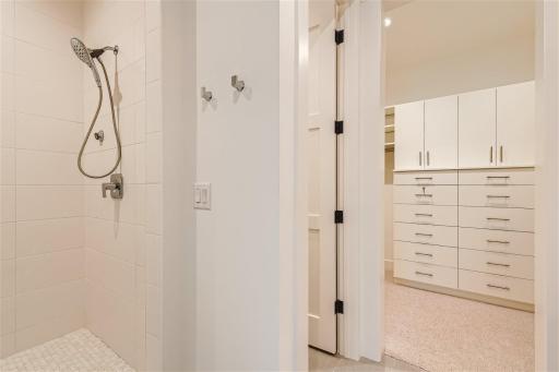 Primary bathroom suite with heated floors and walk in tile shoewr.