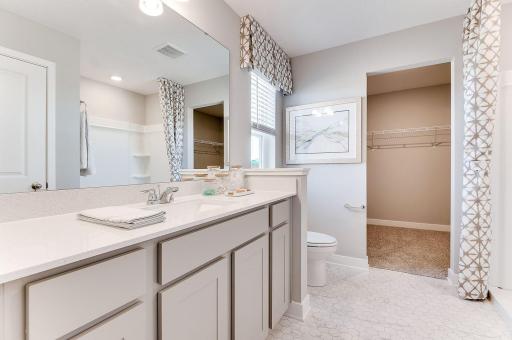 Private ensuite bathroom off primary with walk-in shower. Photo of model home, color & options will vary.