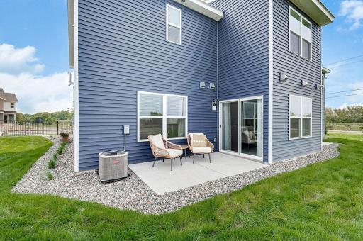 Enjoy Summer evenings on your private rear patio! Photo of model home, color & options will vary.