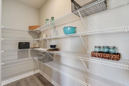 Expansive walk in pantry. *PHOTO OF PREVIOUS MODEL. SELECTIONS MAY VARY