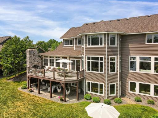 Back of home featuring two story fireplace/wall with 2 wood burning fireplaces