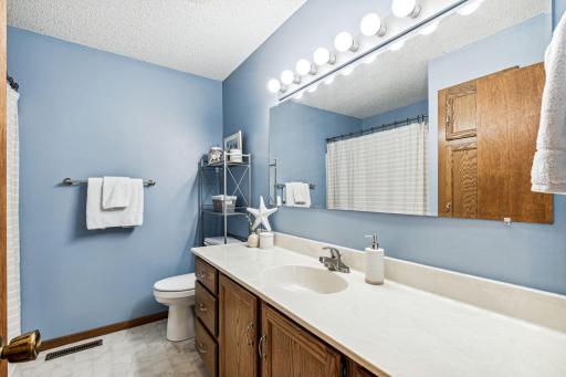 The main floor bath offers a large vanity and counter top space for morning convenience. A built in linen closet is the perfect place for towels and toiletries.
