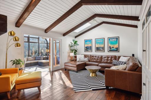 Main floor living room with shiplap and exposed beams