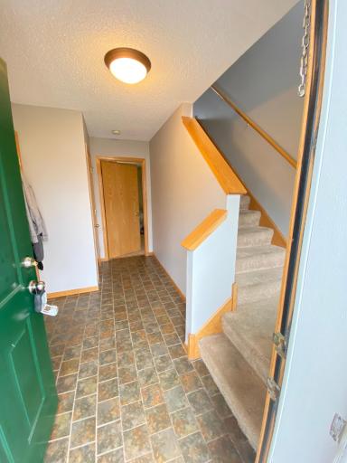 Foyer with tile floor leads to private primary bedroom and bathroom
