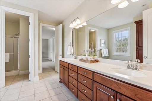 Jack and Jill bathroom with dual sink vanity and tile flooring.