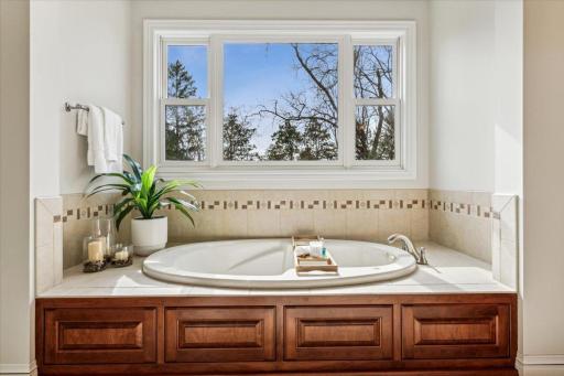 Pamper yourself if the jetted tub with beautiful custom tile surround.