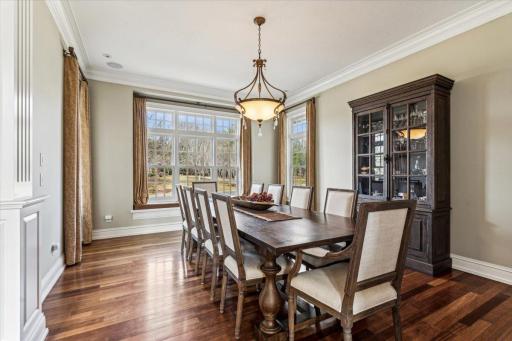 Captivating Dining Room features 3 windows, chandelier and hardwood floors. Perfect for hosting dinner parties in style!