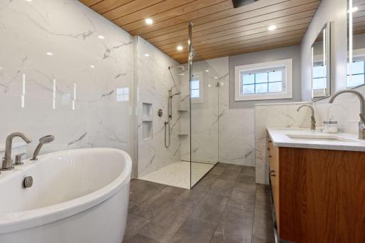 Beautifully updated private primary bathroom space with relaxing tub and walk in shower, two sinks & heated floors!