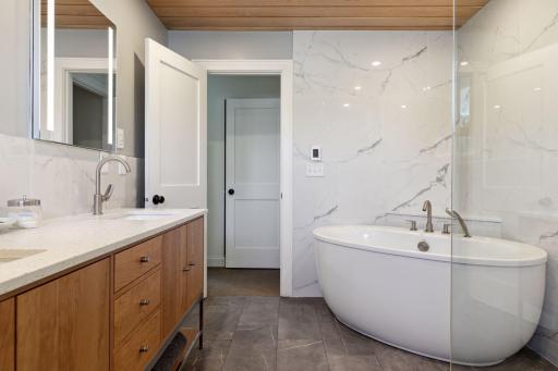 Beautifully updated private primary bathroom space with relaxing tub and walk in shower, two sinks & heated floors!