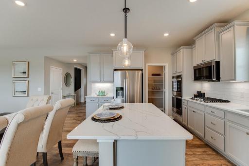 Thoughtfully-designed with a combination of functionality and modern design, this kitchen space is sure to impress. Photo of model home, color and options will vary. Photo of model home, color and options will vary.