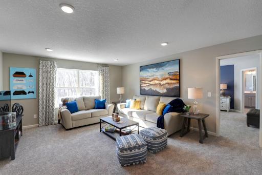 Upstairs, the entire layout flows from the focal point offered by a huge loft space. This area is sure to become a family favorite hangout spot! Photo of model home, color and options will vary.