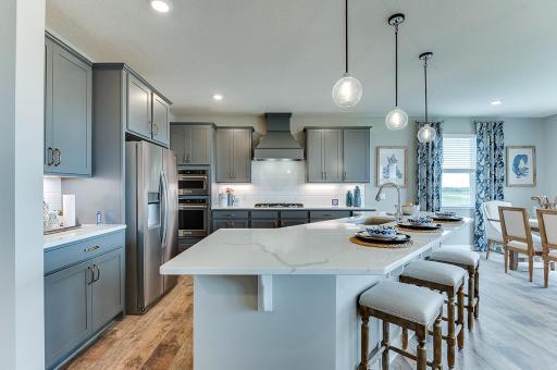 Quartz countertops, stunning backsplash, and more cabinet and counter space than you can imagine! Welcome to the family chef's dream!! *Photo of model home - colors and options may vary*