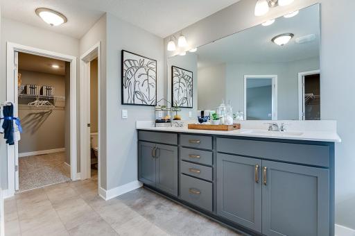 A second peak inside the bathroom off the Primary Suite. Notice the extra high cabinets and double-bowl Quartz covered vanity with loads of storage.
*Photo of model home - colors and options may vary*