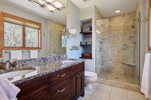 Primary 3/4 bath with granite counter tops and premium tile