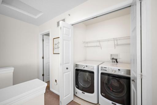 Conveniently located upper level laundry with newer washer and dryer