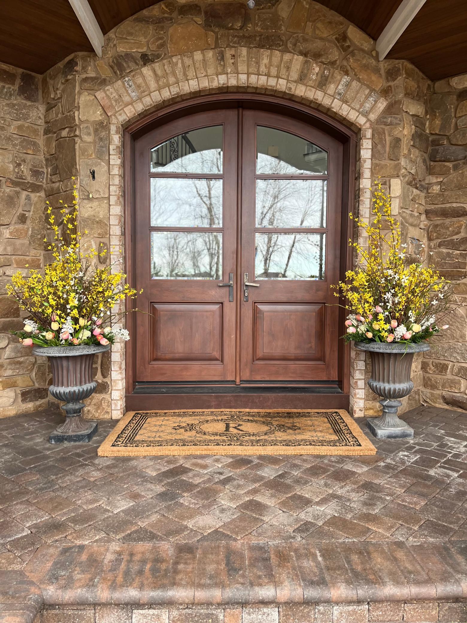 Inviting entry with covered paver front porch