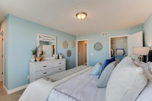The primary bedroom has the benefit of 2 separate closets! Model home photo, colors and selections may vary.