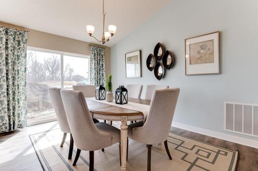 Dining space next to the sliding glass door allow for great outdoor views while enjoying a dinner or quiet evening. *Pictures are of model home; actual finishes may vary.