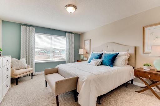 The spacious primary suite has room for not only a king-sized bed, but also a chair for quite reading and an oversized dresser. *Pictures are of model home; actual finishes may vary.