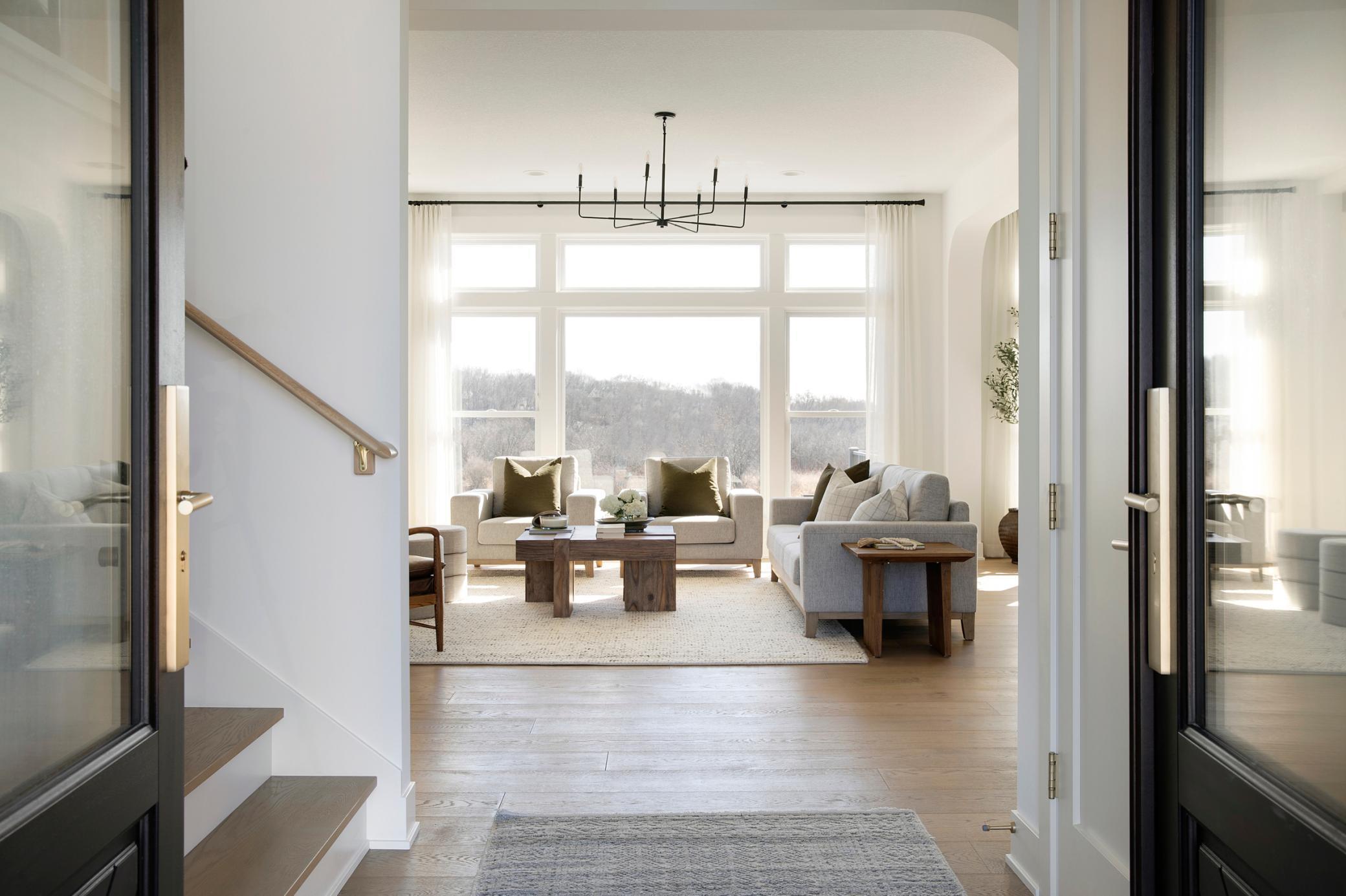 Inviting front foyer with immediate long view off the back through the great room