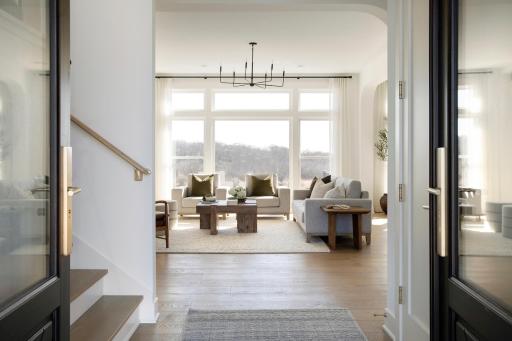 Inviting front foyer with immediate long view off the back through the great room
