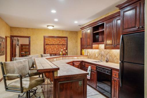 Full bar with sink, dishwasher, and refrigerator.