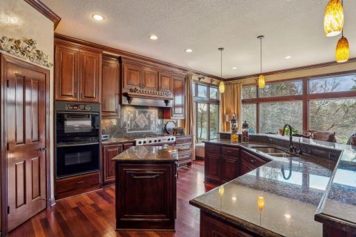 Custom cherry cabinets in the gourmet kitchen with built-in double oven, top of the line cooktop, and two center islands!