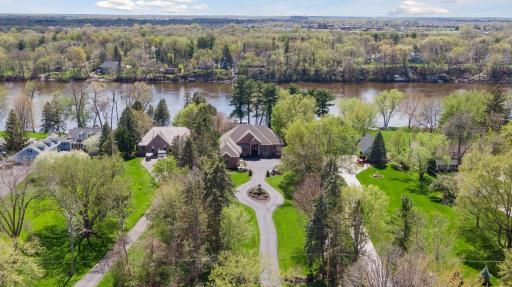 Long driveway along well manicured grounds leading you to home surrounded by mature trees.