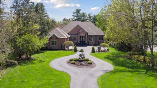 Turnaround in driveway with well appointed landscaping.