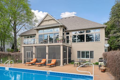 Rear view of the home showcasing an abundance of oversized windows for natural light and amazing views of the river from nearly every room.