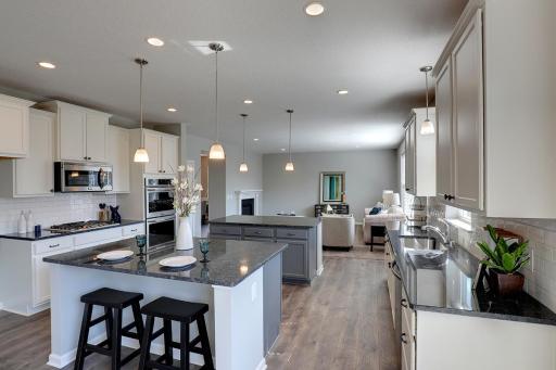 A great angle of all the space in this kitchen, this home would be perfect for entertaining! MODEL HOME PHOTOS, COLORS AND SELECTIONS MAY VARY.