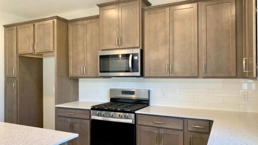 Photo for 1655 Oak Creek Drive, Chaska, MN 55318 - Listing #6501372 Well appointed finishes including quartz countertops, tile backsplash, maple cabinetry, pull out recycle center and soft close doors and drawers. Actual photo of home!