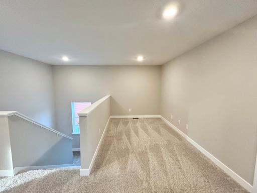 Another view of the upper level loft. Just steps from one of the secondary bedrooms. Actual photo of home.