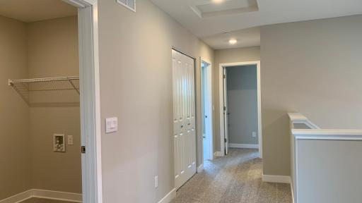 Upper level hall with large linen closet and upper level laundry room.
