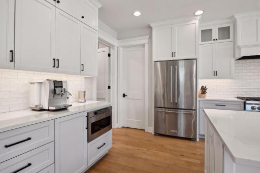 Sleek design elements, SS appliances, large walk-in pantry and great cabinet space for storage