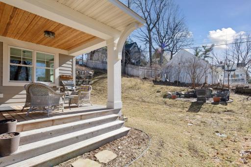 Outdoor gathering spaces include the covered porch and fire pit