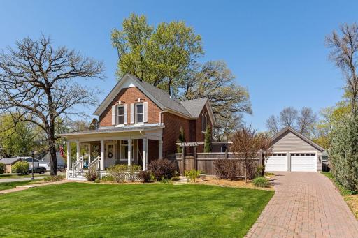 Gorgeous updated & one-of-a-kind brick French Country Farmhouse w/heated 2 car garage on double XL lot. This pic was taken right before current owner purchased to show off the landscaping and green grass.